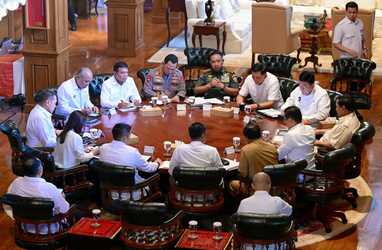 President Prabowo Subianto (right) talks to his ministers during a limited cabinet meeting at his private residence in Hambalang, Bogor regency, West Java, on June 23.