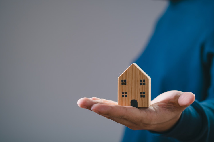A stock illustration of a wooden miniature of a house.