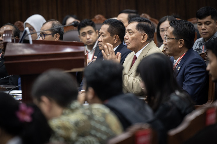 Defense Minister Sjafrie Sjamsoeddin (second right) and Law Minister Supratman Andi Agtas (right) attend a judicial review petition hearing for the Indonesian Military (TNI) Law revision on Monday at the Constitutional Court in Jakarta. Representatives from the government and House of Representatives argued that the plaintiffs lack a legal standing.