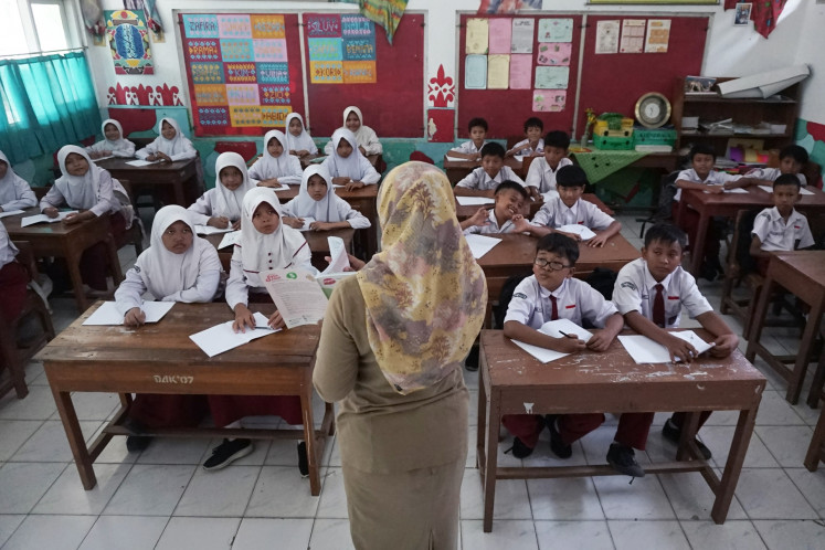 A contract teacher teaches a classroom at the SD Proyonanggan 01 state elementary school in Batang regency, Central Java, on June 3, 2025.