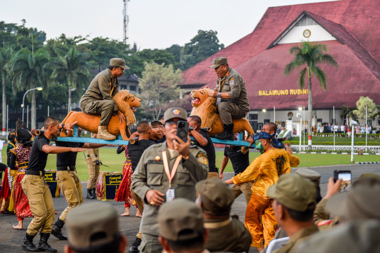 Wrapping up: Bali Governor I Wayan Koster (left) and Bangka Belitung Governor Hidayat Arsani (right) ride a sisingaan (traditional lion effigy) on Thursday during the closing ceremony of the second wave of the regional leaders’ retreat at the Institute of Public Administration (IPDN) in Jatinangor, Sumedang Regency, West Java. The second wave of the retreat, which was attended by 86 regional heads, officially concluded after four days of sessions on national identity strengthening, fiscal policy, economic growth, national strategic programs and healthcare services.