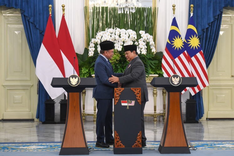 President Prabowo Subianto (right) shakes hands with Malaysian Prime Minister Anwar Ibrahim (left) during a press conference following a bilateral meeting at the Merdeka Palace, Jakarta, on June 27, 2025.  