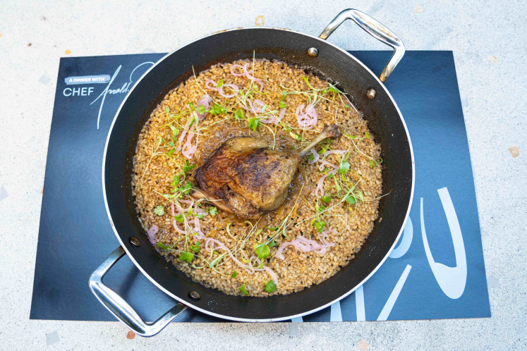 Slow-braised duck leg over seasoned rice and pickled shallots, the duck confit offers a different take using the same core ingredients.