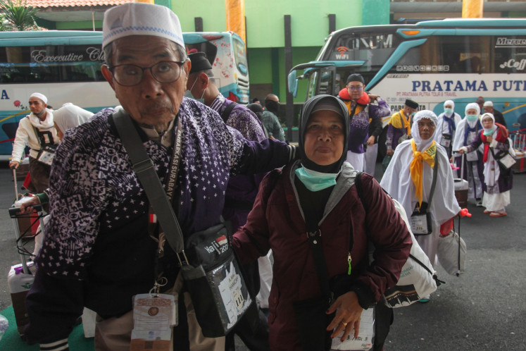 Safe and sound: Pilgrims from the SUB 44 flight group of the Surabaya embarkation point walk into the Sukolilo haj dormitory in Surabaya, East Java, on Wednesday. The pilgrims' flight to Indonesia was delayed after the Muscat International Airport in Oman was temporarily closed following an Iranian attack against an air base in Qatar on June 23.