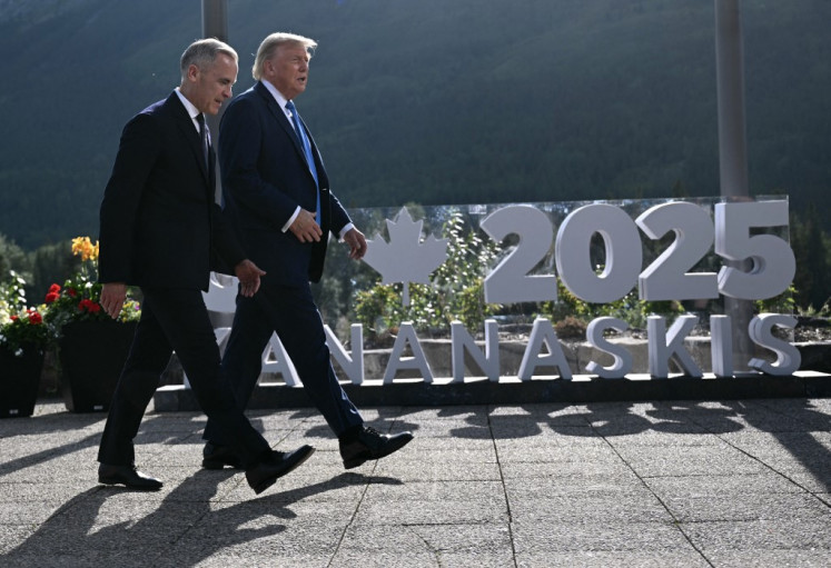Canadian Prime Minister Mark Carney (left) and US President Donald Trump arrive for a family photo during the Group of Seven (G7) Summit at the Kananaskis Country Golf Course in Kananaskis, Alberta, Canada, on June 16, 2025.