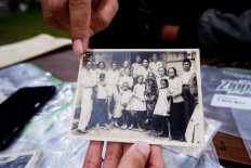 Rangga Purbaya points to his grandfather, who went missing in 1965, in an old black-and-white photograph. He was a teacher at Taman Siswa Bangka Belitung, which was associated with the Indonesian Communist Party (PKI). 