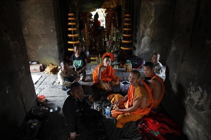 A group of young Buddhist monks and children sit at the 11th-century Preah Vihear temple on the border between Thailand and Cambodia on Feb. 8, 2011. 

