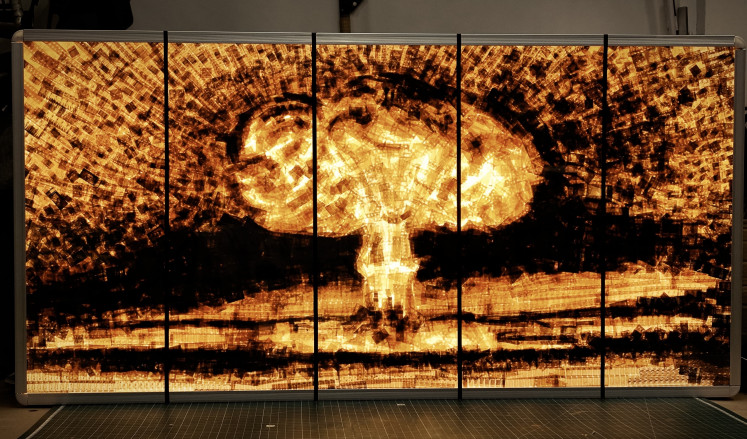 AWARE OF DANGER by Awan Simatupang, made of celluloid cinema film cuts, is 5x2 meters.