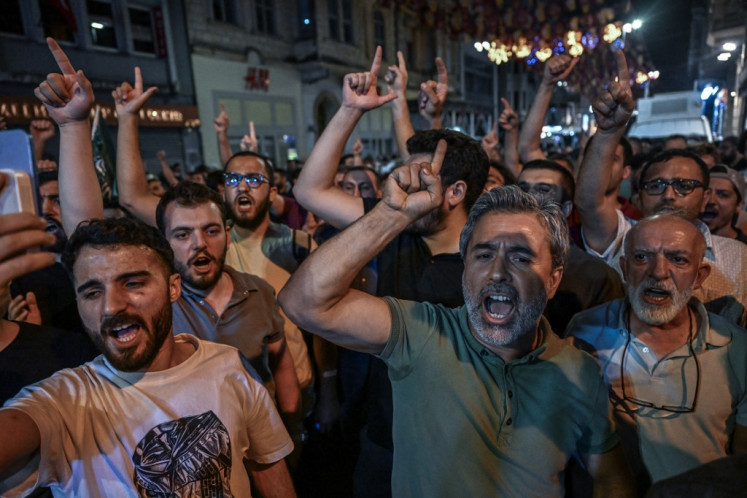 Islamist protesters shout slogans against cartoonists as they gather at Istiklal avenue near Leman Magazine  in Istanbul on June 30, 2025. 
