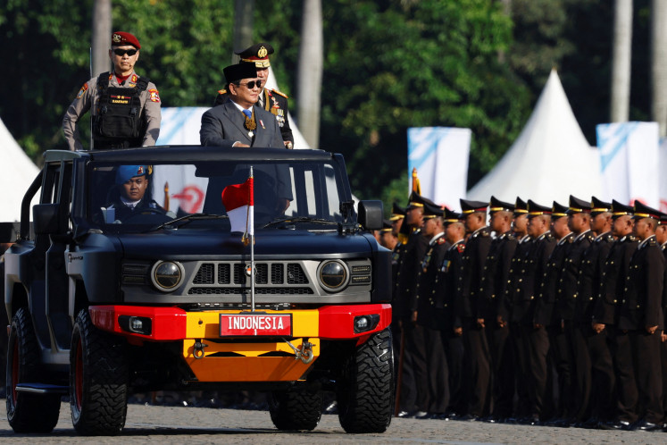 President Prabowo Subianto accompanied by the National Police Chief Gne. Listyo Sigit Prabowo ride in a vehicle while inspecting troops during a ceremony to mark the 79th anniversary of the police at the National Monument (Monas) in Jakarta on July 1.