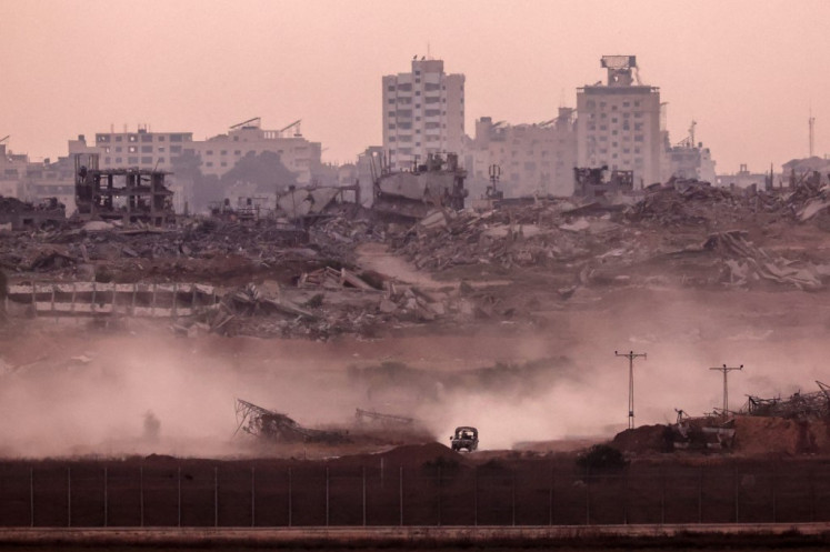 This picture taken from a position on the Israeli border with the Gaza Strip, shows an Israeli vehicle returning from the Palestinian territory on July 1, 2025.