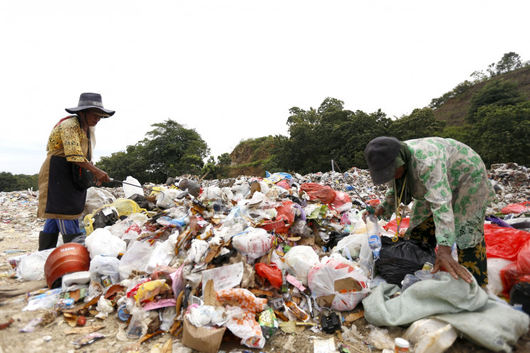 Trash pickers look for plastic waste at the Talumelito Landfill in Gorontalo regency, Gorontalo, on June 30.