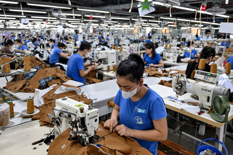 Workers stitch apparel at a garment factory in Vietnam's Thai Nguyen Province on July 2, 2025. Vietnam, a global manufacturing hub reliant on exports, would face a 20 percent tariff on goods shipped to the US, lower than the 46 percent announced in April.