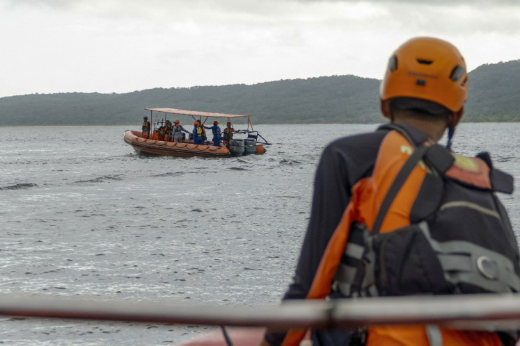 Rescuers search for missing victims of a ferry accident in the waters off the Bali Strait in Jembrana, Bali, on July 4, 2025. 