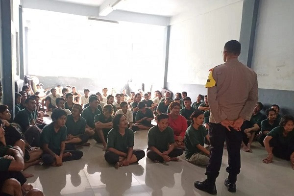 Seeking shelter: A police officer explains law enforcement protocols related to homelessness to individuals grappling with social issues at the Bina Insan Bangun Daya social shelter in Kedoya, West Jakarta on Jan. 23, 2024.