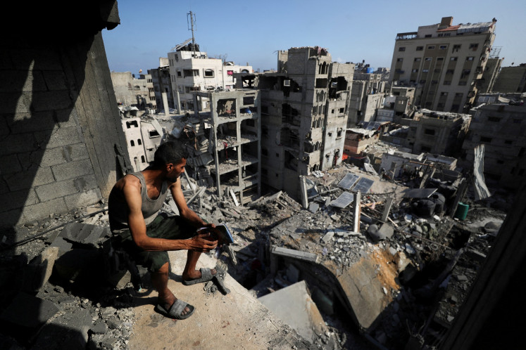 A Palestinian looks on at the site of Thursday's Israeli strike that damaged and destroyed residential buildings at Shati (Beach) refugee camp in Gaza City, on July 4, 2025.