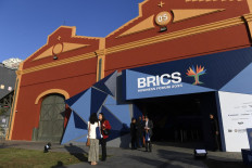 Attendees stand at the entrance to the BRICS Business Forum in Rio de Janeiro, Brazil, on July 5.