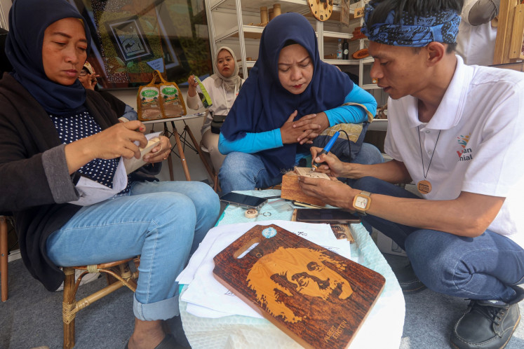 Participants carve wood on June 24, 2025, during a creative economy training workshop in Bogor, West Java.
