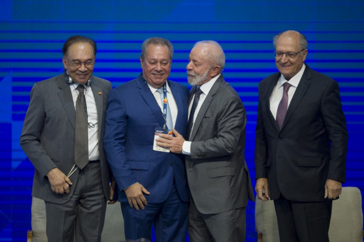 (Left to right) Malaysia's Prime Minister Anwar Ibrahim, the president of the Brazilian Industry Conference, Ricardo Alban, Brazil's President Luiz Inacio Lula da Silva, and Brazil's Vice President and Minister of Industry and Trade Geraldo Alckmin attend the BRICS Business Forum in Rio de Janeiro, Brazil, on July 5, 2025. 
