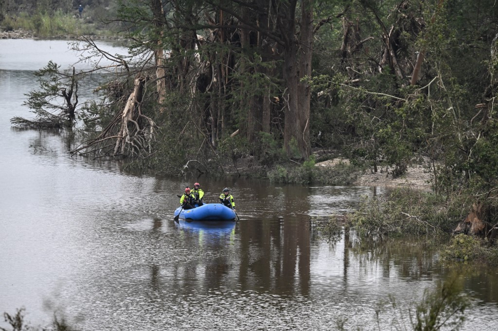 Members of a rescue team look for missing people on the Guadalupe River in Kerrville, Texas, United States, on July 6, 2025, following severe flash flooding that occurred during the July 4 holiday weekend. Rescuers in Texas raced against time Sunday to find dozens of missing people, including children, swept away by flash floods that killed at least 78, as forecasters warned of new deluges. Local Texans joined forces with disaster officials to search through the night for the missing, including 27 girls from a riverside Christian summer camp.