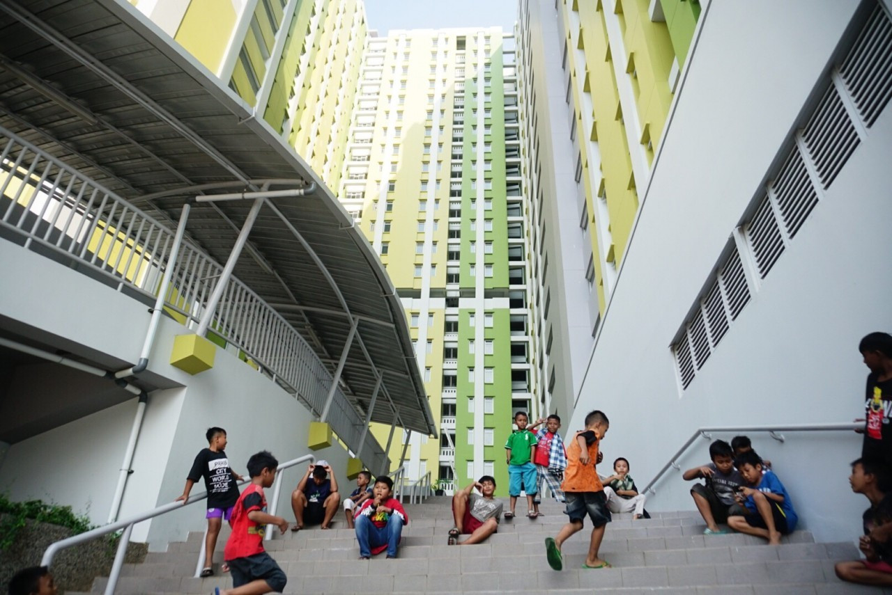 Children play on Oct. 20, 2019 along a set of stairs at Rusun Pasar Rumput, a low-cost apartment complex that is part of a mixed-use development in South Jakarta. 
