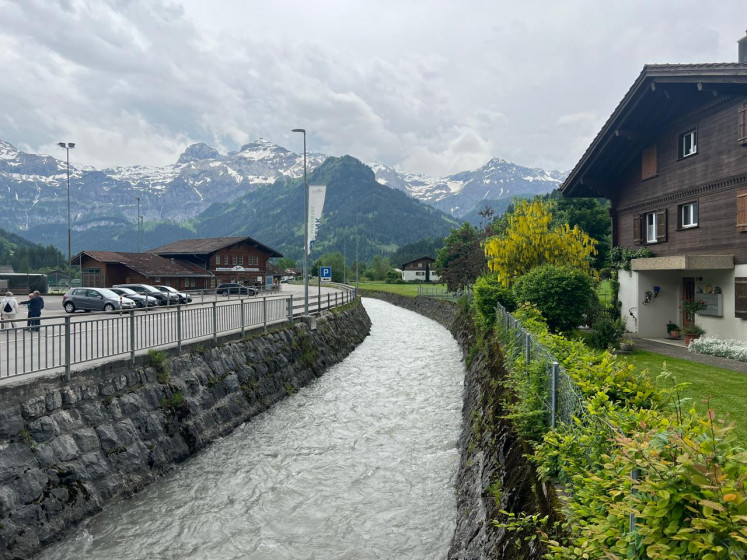 Serene hazard: The river Simme flows along an embankment through Lenk im Simmental from Plaine Morte (Dead Plain), a glacier situated at a height of up to 2,840 meters above sea level in the Bernese Alps. Its glacial lake drained spontaneously in 2018 and caused flooding in the village. JP/Radhiyya Indra