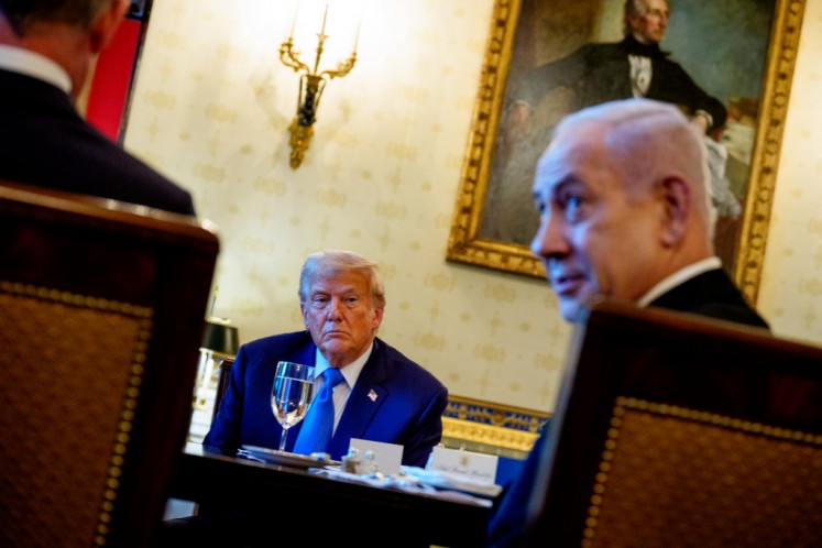Israeli Prime Minister Benjamin Netanyahu, accompanied by US President Donald Trump (left), speaks during a dinner in the Blue Room of the White House on July 07, 2025 in Washington, DC. 