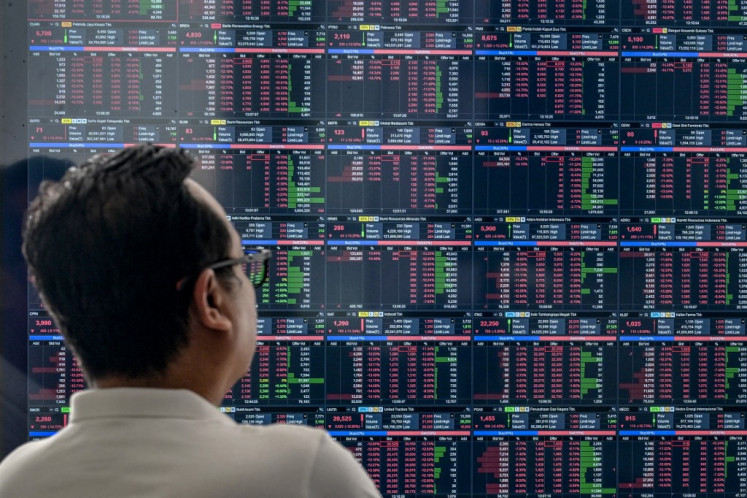 A trader monitors the Indonesia Stock Exchange (IDX) Composite index on April 8 in South Tangerang, Banten. 