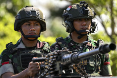 Soldiers from the Indonesian Army's 112th Raider Infantry Battalion secure a ceremony at a military base in Japakeh, Aceh, on June 25, 2024, ahead of their deployment to Papua. 