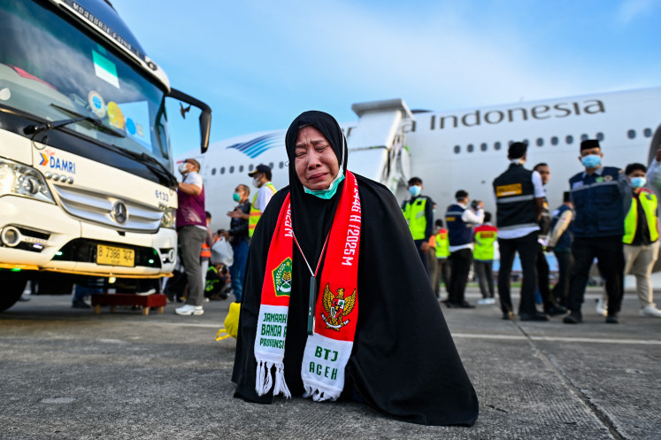 A returning pilgrim reacts on June 28 upon arrival at Sultan Iskandar Muda International Airport in Blang Bintang, Aceh, after performing the annual haj pilgrimage.