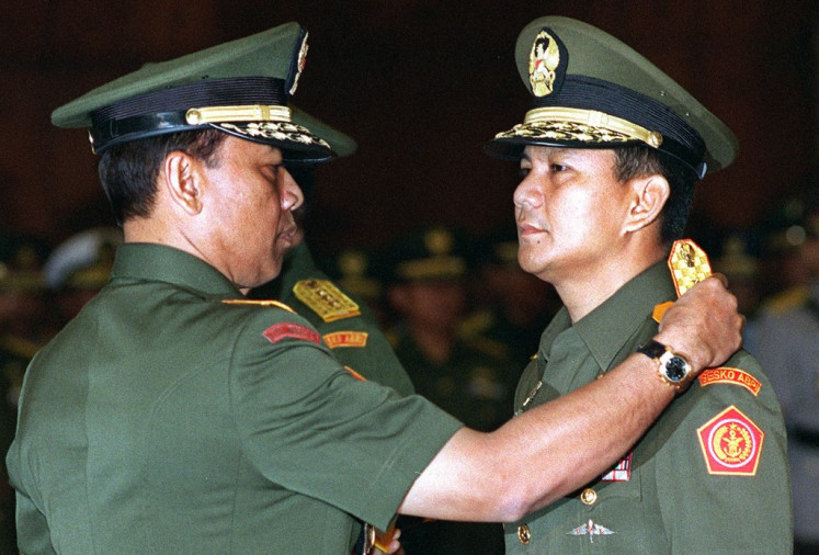 Then Indonesian Armed Forces Commander Gen. Wiranto (left) removes the Army's Strategic Reserves Commander epaulet from Lt. Gen. Prabowo Subianto, now the country's president, during a handover ceremony at the military headquarters in Jakarta on May 28, 1998. In the late 1990s, deadly riots preceded Indonesian dictator Suharto's fall, but the government says the vengeful bloodbaths that mostly targeted ethnically Chinese Indonesians will be skipped in a forthcoming revision of its official history books.