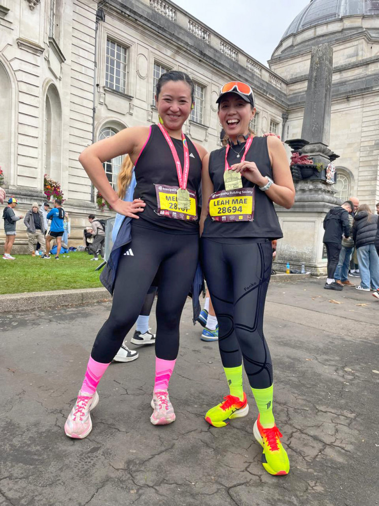 Jet Damazo with her running buddy in Cardiff in 2024, after finishing the first of the six SuperHalfs half marathons.