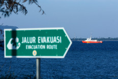 The KN SAR Arjuna 229 search and rescue boat sails in the Bali Strait on July 9 during a joint search and rescue mission to rescue victims and locate the KMP Tunu Pratama Jaya ferry that sank on July 2, as seen from Boom Beach in Banyuwangi, East Java.