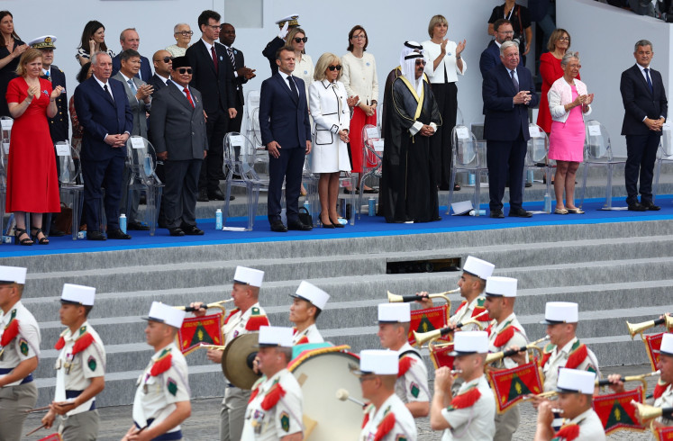 French President Emmanuel Macron (fourth left), his wife Brigitte Macron (fifth right), President Prabowo Subianto (fourth right), Kuwait's Emir Sheikh Mishal Al-Ahmad Al-Jaber Al-Sabah (fourth right) and members of the French government attend the annual Bastille Day military parade on the Place de la Concorde in Paris on July 14, 2025.