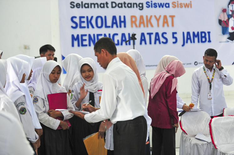 A teacher collect data on Sekolah Rakyat students ahead of the health examination at the SRMA 5 Jambi Sekolah Rakyat senior high school in Jambi on July 14, 2025.