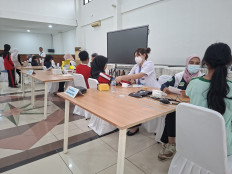 Health workers perform medical examinations on Sekolah Rakyat students at the school's site in the Social Affairs Ministry's training center in South Jakarta on July 14, 2025.