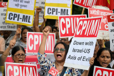 Activists and supporters of Communist Party of India (Marxist-Leninist) hold placards on June 25 as they condemn United States strikes on Iran during a protest in New Delhi.