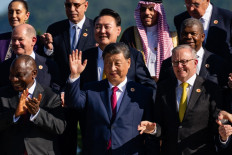 Chinese President Xi Jinping (center) gestures as he stands alongside Australian Prime Minister Anthony Albanese (right) during a group photo with G20 leaders at the G20 Summit in Rio de Janeiro, Brazil, on November 18, 2024.