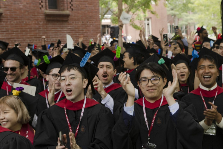 New graduates celebrate on May 29, 2025, during their commencement ceremony at the Harvard Graduate School of Design in Cambridge, Massachusetts.