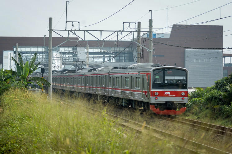 A set of the Commuter Line urban train passes next to the under-construction Jatake Station in Tangerang regency, Banten on July 16, 2025.