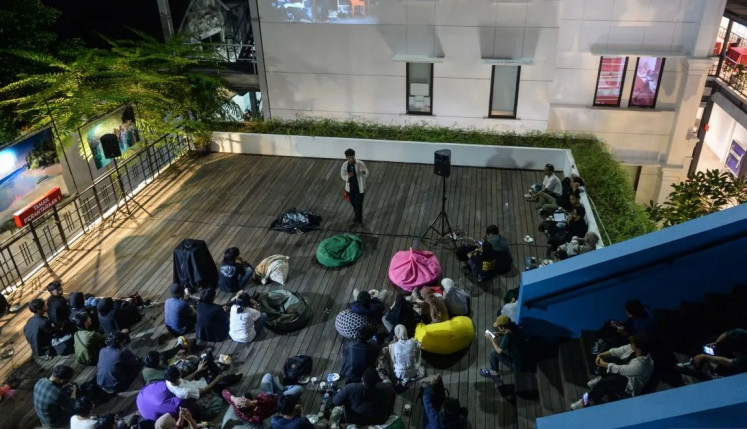 Photo talks: A photographer presents his pictures during a discussion at Antara Heritage Center in Central Jakarta on July 11, 2025.