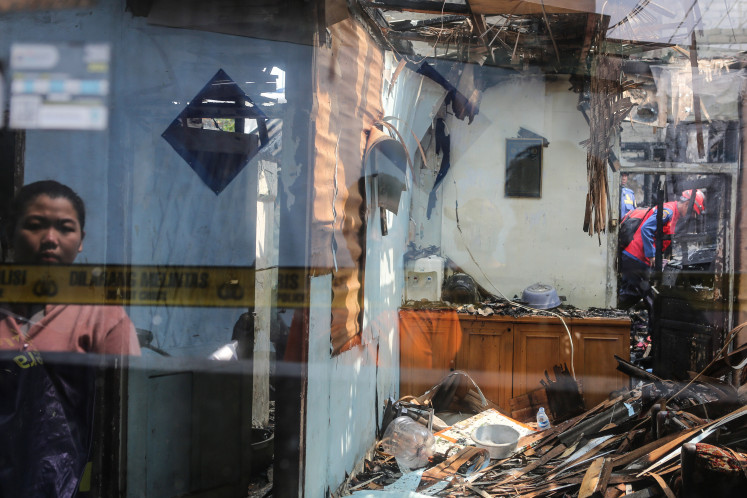 Fatal flaw: A group of people gathers on July 19, 2025, at the site of a house destroyed by fire on Jl. Kutilang in Bukit Duri, Tebet, South Jakarta. Four children were killed and four other people were injured in the fire that engulfed three rented houses, according to data from the South Jakarta Fire and Rescue Agency.