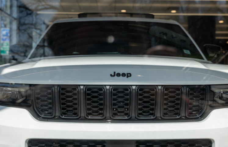 Jeep vehicles are displayed in a dealership window in Manhattan on April 01, 2025 in New York City, US. 