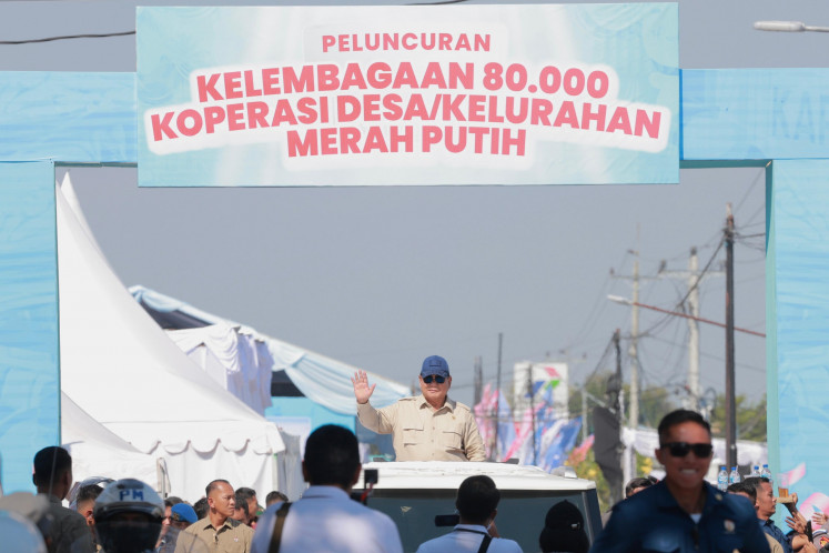 President Prabowo Subianto salutes the crowd from his vehicle ahead of inaugurating the establishment of 80,081 cooperatives under the initiative of Red and White Village Cooperatives in a national rollout ceremony held in Bentangan village, Klaten, Central Java, on Monday, July 21, 2025.
