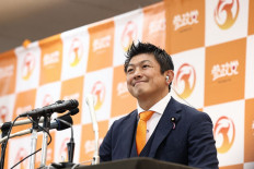 Japan's opposition party Sanseito leader Sohei Kamiya smiles as he speaks to members of the media at the vote counting center in Tokyo on July 20, 2025.