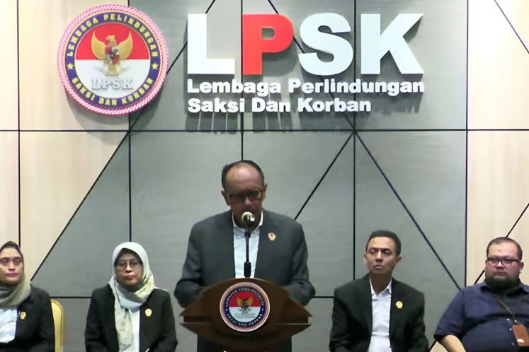 Chair of the Witness and Victim Protection Agency (LPSK) Achmadi speaks as agency members look on during a media conference in Jakarta on June 11, 2024.