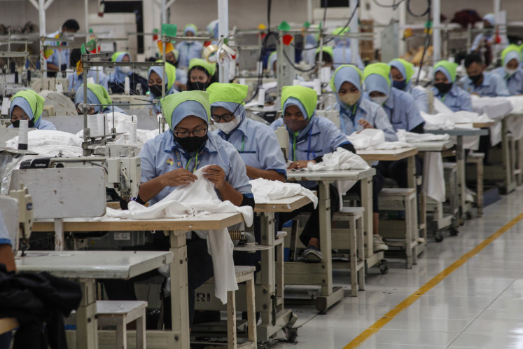 Workers are pictured at a factory of fabric and garment producer PT Sari Warna Asli in Surakarta, Central Java, on July 17, 2025.