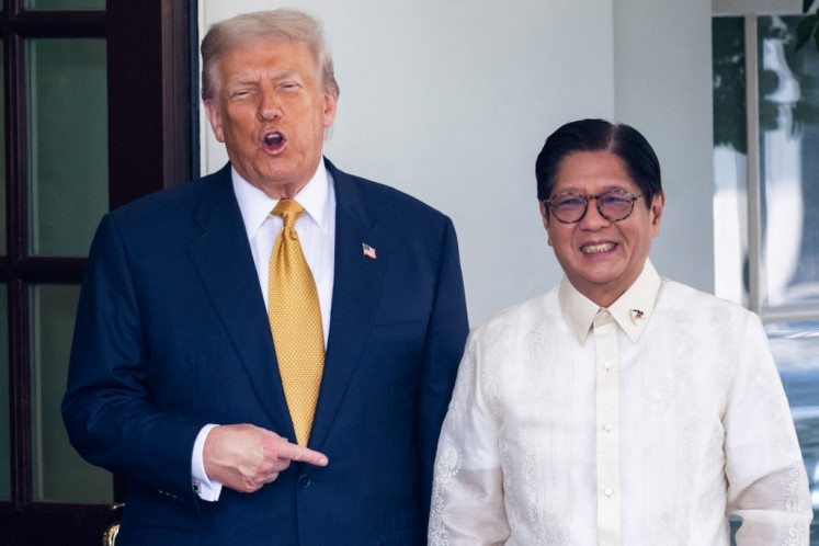 United States President Donald Trump (left) gestures on July 22, 2025, as he welcomes Philippine President Ferdinand Marcos Jr at the entrance to the West Wing of the White House in Washington, DC.