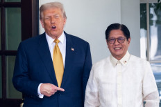 United States President Donald Trump (left) gestures on July 22, 2025, as he welcomes Philippine President Ferdinand Marcos Jr at the entrance to the West Wing of the White House in Washington, DC.
