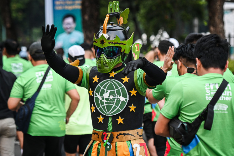 A runner clad in a costume gestures during the 5K Run Fest July 20 in Jakarta. The event was organized by the National Awakening Party (PKB) to commemorate its anniversary.
